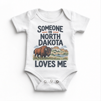 Someone in North Dakota Loves Me design on a white baby bodysuit
