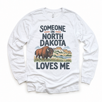 Someone in North Dakota Loves Me design on a white long sleeve T-shirt