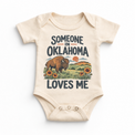 Someone in Oklahoma Loves Me design on a natural beige baby bodysuit
