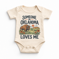 Someone in Oklahoma Loves Me design on a natural beige baby bodysuit