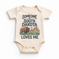 Someone in South Dakota Loves Me design on a natural beige baby bodysuit