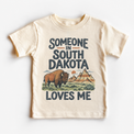 Someone in South Dakota Loves Me design on a natural beige short sleeve T-shirt