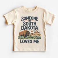 Someone in South Dakota Loves Me design on a natural beige short sleeve T-shirt