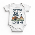Someone in South Dakota Loves Me design on a white baby bodysuit