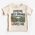 Someone in West Virginia Loves Me design on a natural beige short sleeve T-shirt