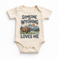 Someone in Wyoming Loves Me design on a natural beige baby bodysuit
