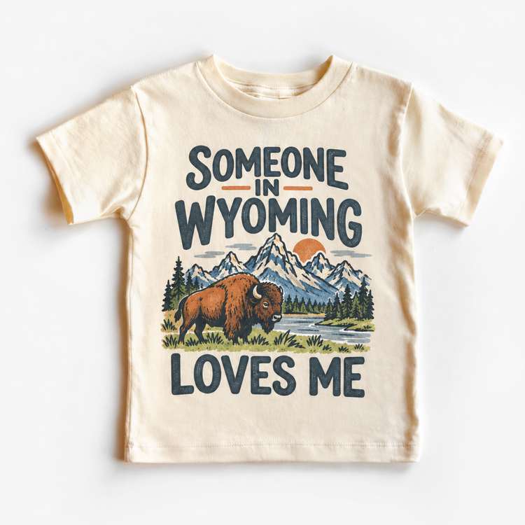 Someone in Wyoming Loves Me design on a natural beige short sleeve T-shirt