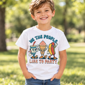 Child wearing a white We The People Like To Party Shirt outdoors